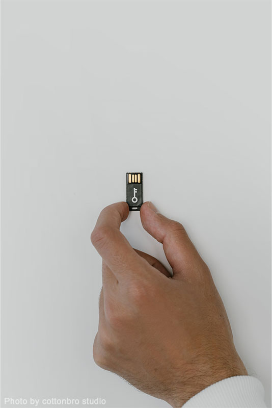 850 person holding USB with key optimized